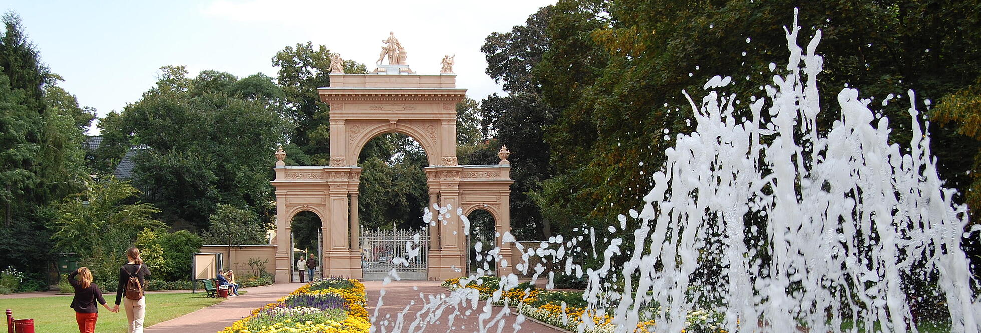 Außenaufnahme zeigt das Eingangsportal zum Bürgerpark Pankow vom Springbrunnen aus gesehen.